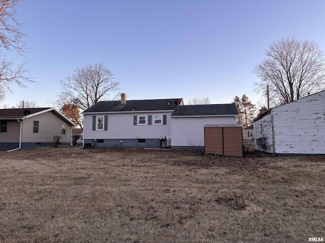 back of property with a lawn and a chimney