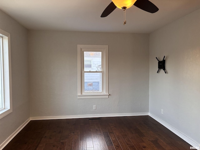 unfurnished room with dark wood finished floors, baseboards, and ceiling fan