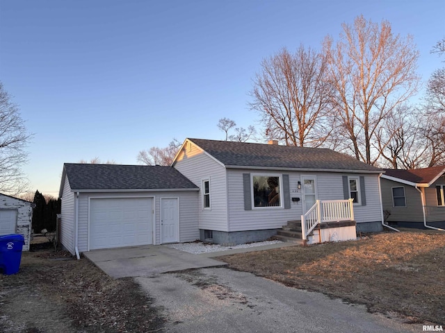 view of front of property featuring a garage, driveway, roof with shingles, and a chimney