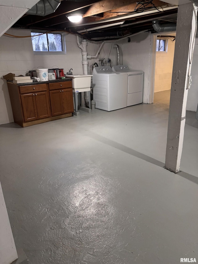 basement with a sink and washing machine and clothes dryer