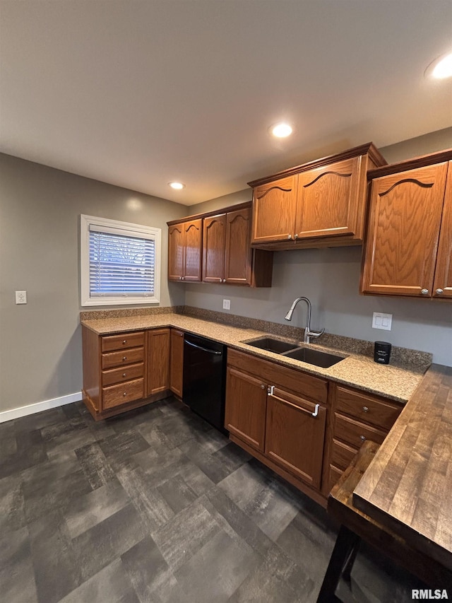 kitchen featuring dishwasher, baseboards, a sink, and recessed lighting