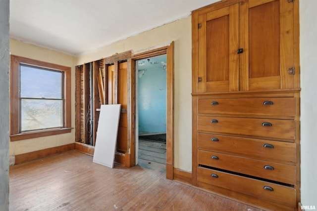 interior space with baseboards and light wood-style floors
