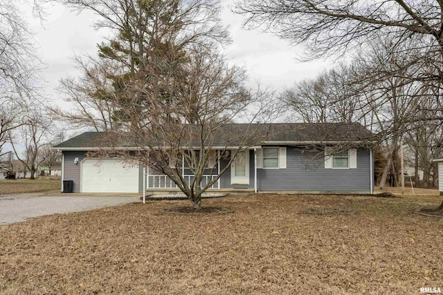 single story home featuring a front yard, driveway, and an attached garage