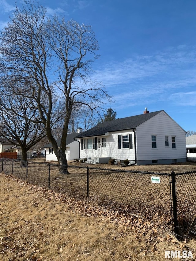 view of front of property featuring a fenced front yard and a chimney