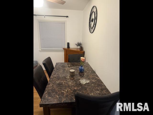 dining area with ceiling fan and wood finished floors