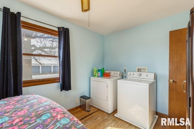 bedroom with ceiling fan, washing machine and clothes dryer, and light wood-style floors