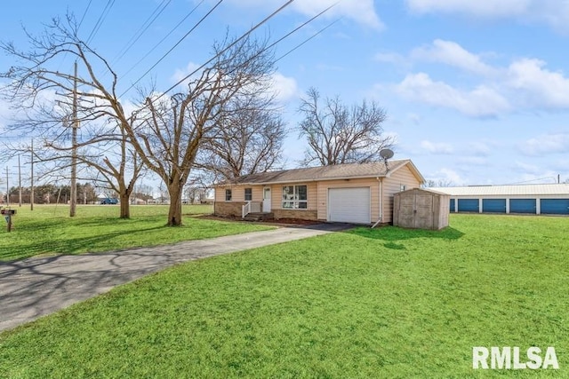 single story home featuring an outbuilding, a front yard, a shed, a garage, and driveway