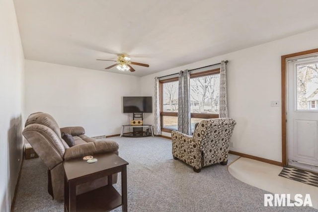 carpeted living room with a ceiling fan and baseboards