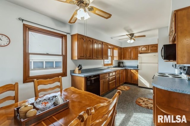 kitchen featuring black appliances, ceiling fan, brown cabinetry, and a sink