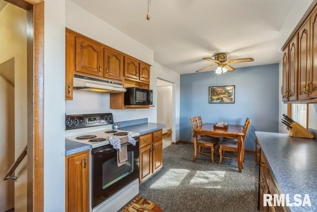 kitchen featuring brown cabinets, dark countertops, electric range oven, black microwave, and under cabinet range hood