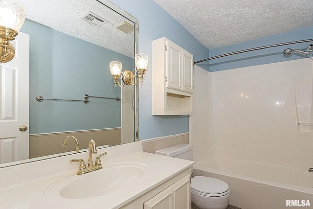 full bathroom with visible vents, washtub / shower combination, toilet, vanity, and a textured ceiling