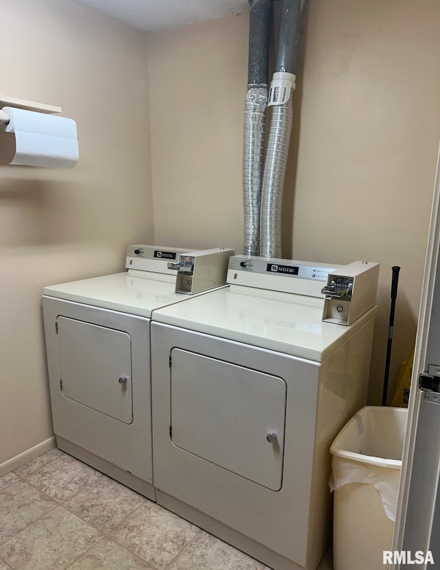 laundry area featuring laundry area, separate washer and dryer, and baseboards