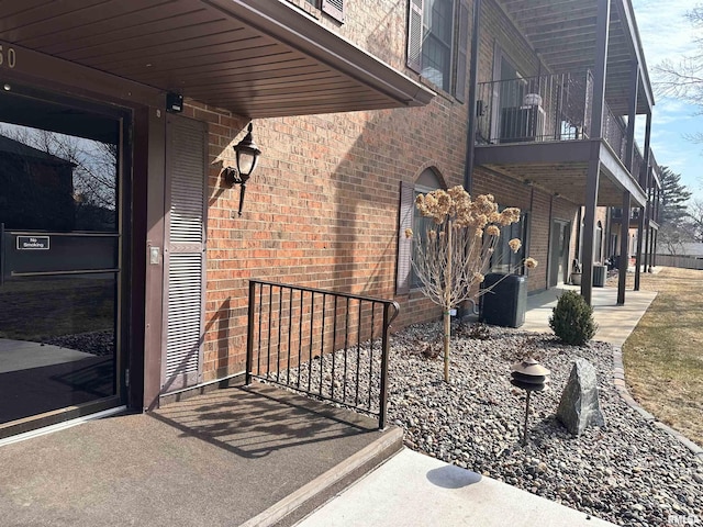 view of home's exterior featuring a balcony and brick siding