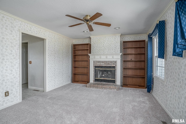 unfurnished living room with crown molding, a brick fireplace, and wallpapered walls