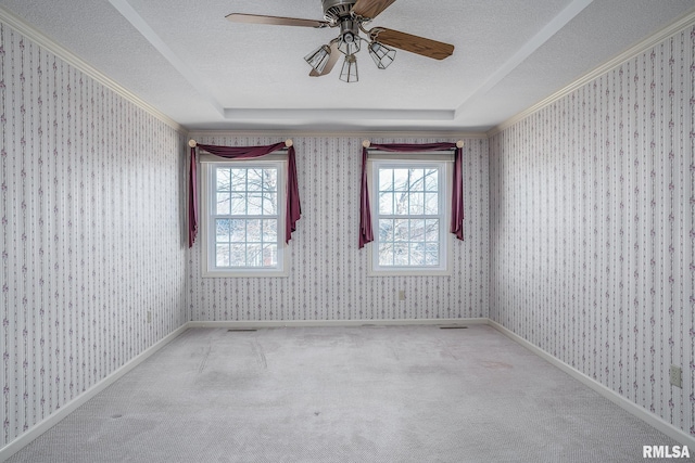 carpeted spare room featuring wallpapered walls, baseboards, and a textured ceiling