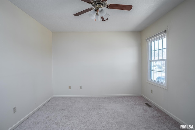 unfurnished room featuring ceiling fan, carpet flooring, visible vents, and baseboards