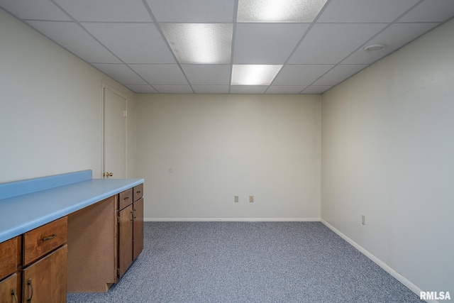 interior space with carpet floors, baseboards, and a paneled ceiling