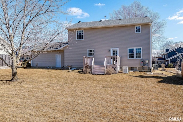 back of property featuring central AC unit, a lawn, and a wooden deck