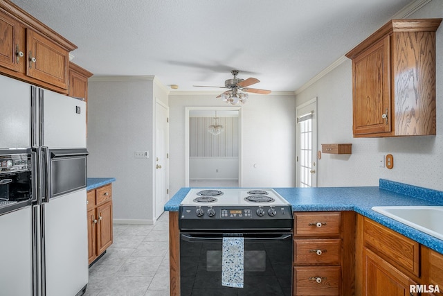 kitchen with black electric range, white refrigerator with ice dispenser, wallpapered walls, and brown cabinets