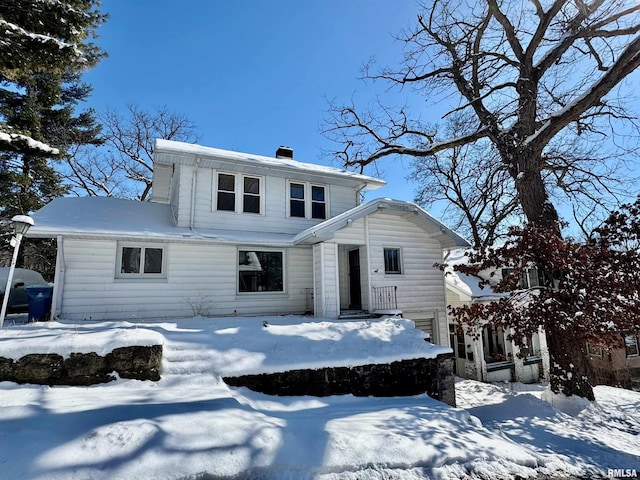 view of front of home with a garage and a chimney