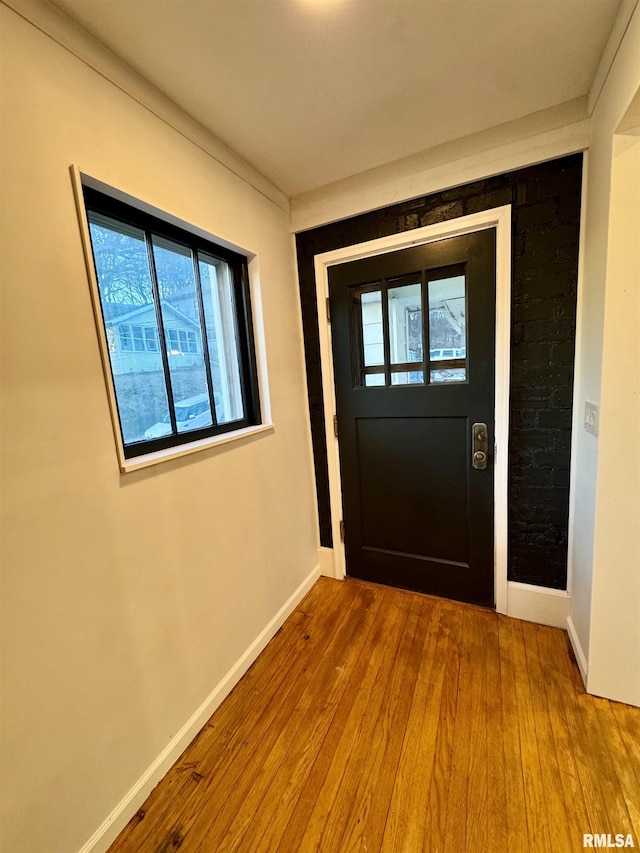 entryway with baseboards and hardwood / wood-style floors