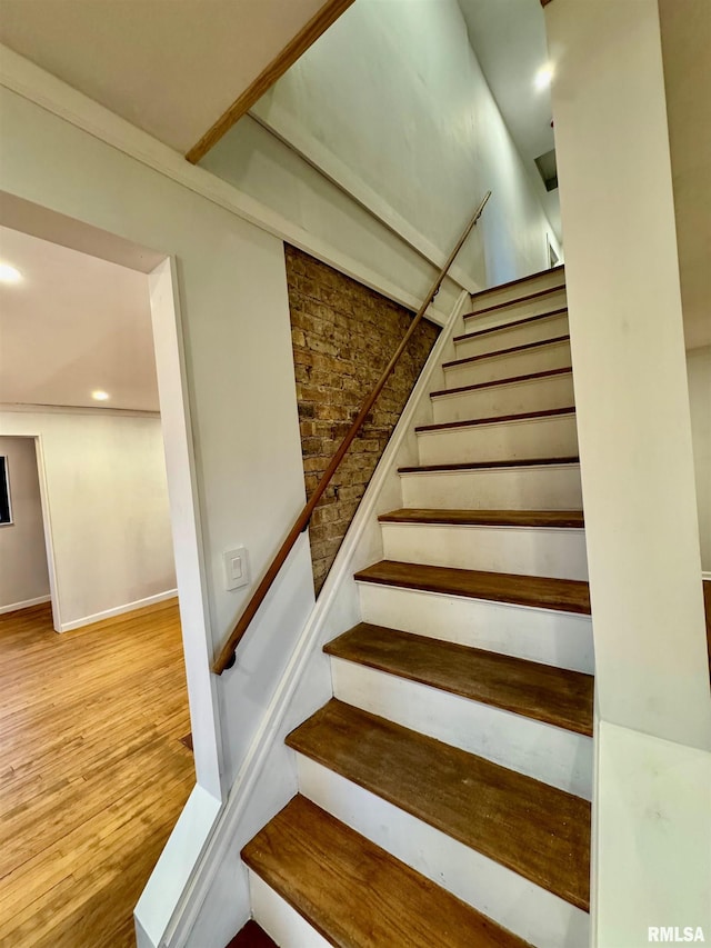 stairway featuring recessed lighting and wood finished floors