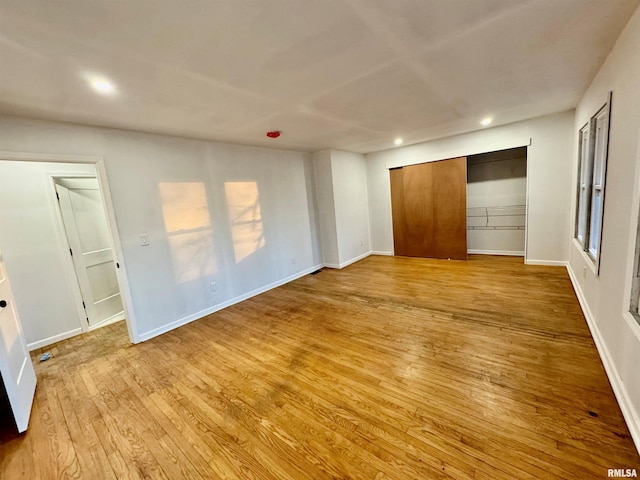 unfurnished bedroom with light wood-type flooring, baseboards, and recessed lighting