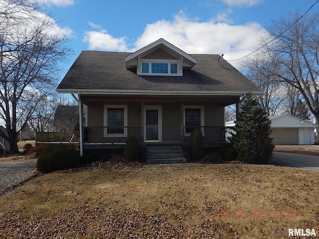 bungalow-style home with a porch, an outdoor structure, and a detached garage