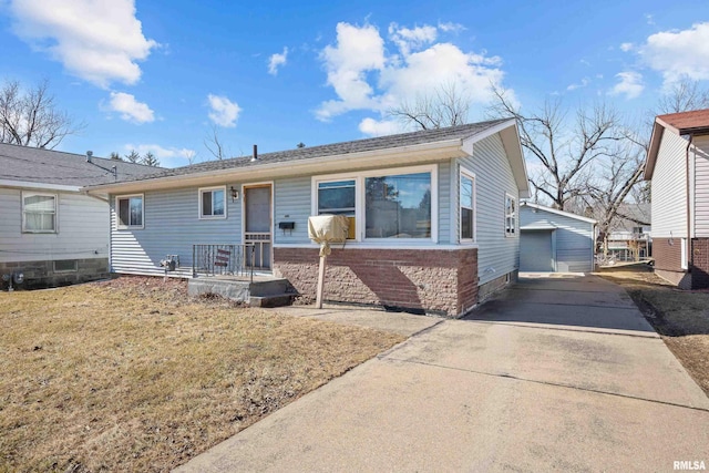 view of front of house with an outdoor structure and brick siding