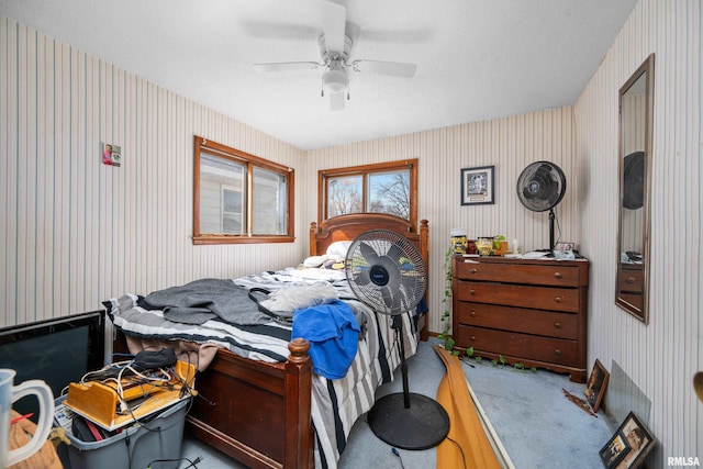 bedroom with carpet floors, wallpapered walls, and ceiling fan