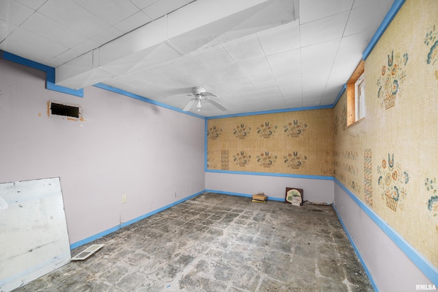 spare room featuring ceiling fan, visible vents, and baseboards