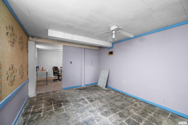 finished basement with ceiling fan and baseboards