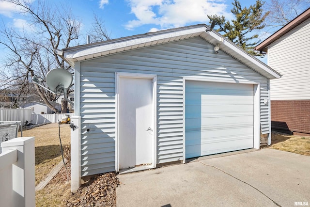 detached garage with driveway and fence