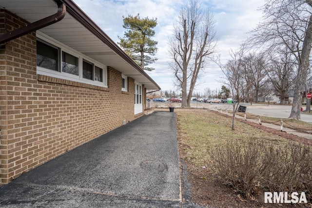 view of property exterior with brick siding