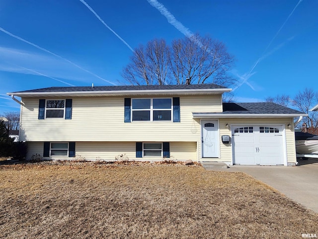 split level home with driveway and an attached garage