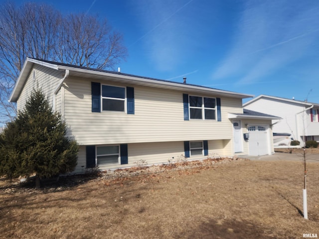 split level home with an attached garage and concrete driveway