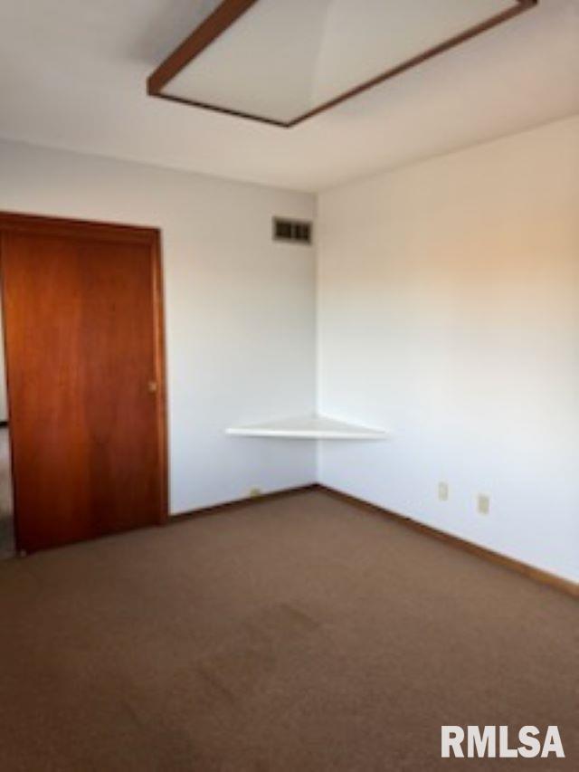 unfurnished bedroom with carpet floors, baseboards, and visible vents