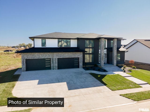 view of front of property featuring stone siding, concrete driveway, and an attached garage