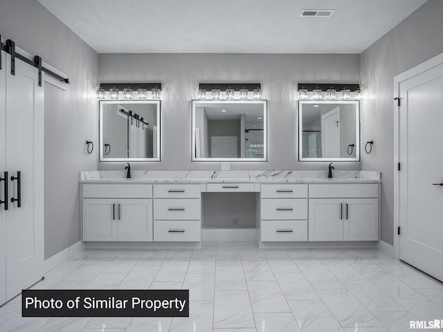 bathroom with marble finish floor, visible vents, a sink, and double vanity