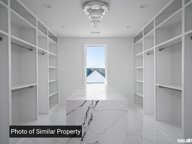 spacious closet featuring marble finish floor and visible vents