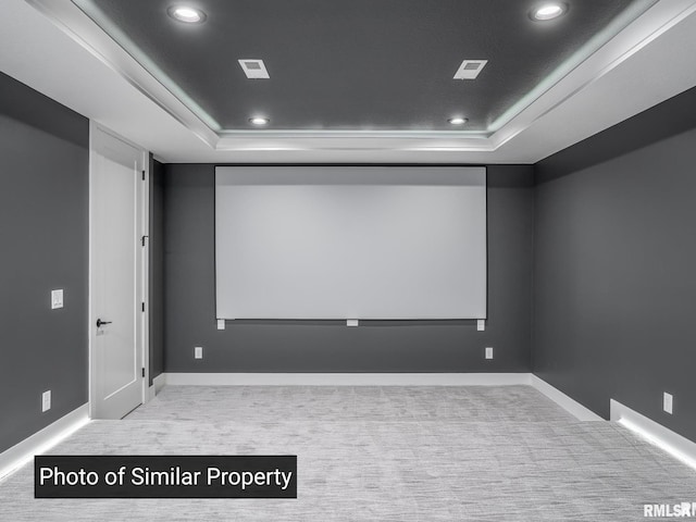 carpeted home theater room featuring baseboards, a tray ceiling, and recessed lighting