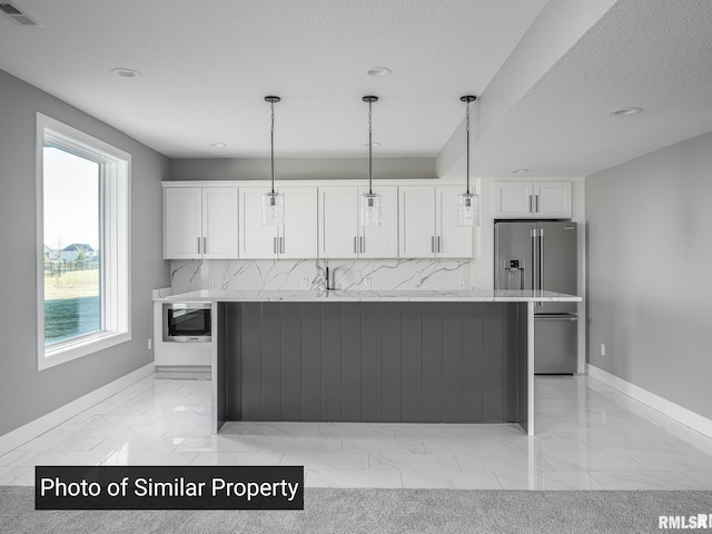 kitchen with marble finish floor, high quality fridge, visible vents, and white cabinets