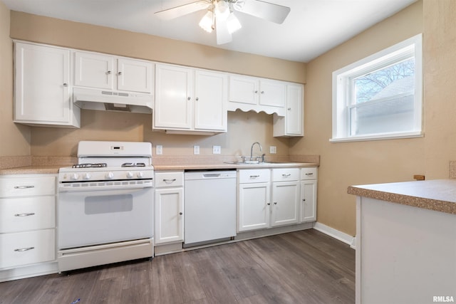 kitchen with under cabinet range hood, white cabinetry, white appliances, and a sink