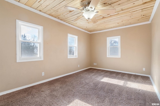 carpeted empty room featuring wood ceiling, plenty of natural light, and crown molding