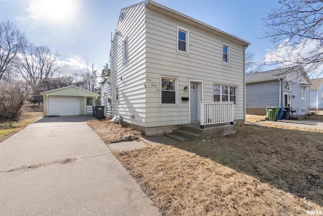 view of front of home with a garage, driveway, and an outbuilding