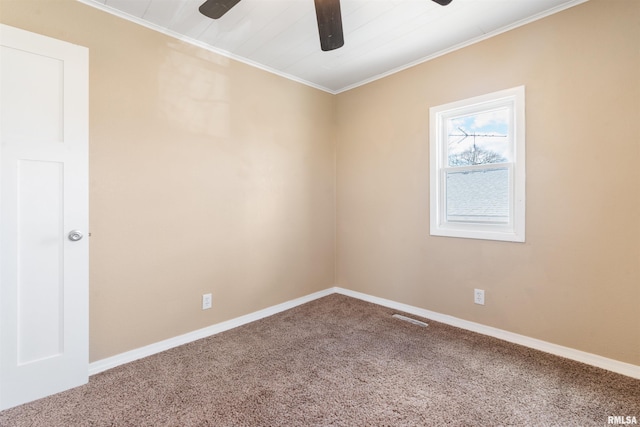 carpeted empty room featuring crown molding, ceiling fan, and baseboards