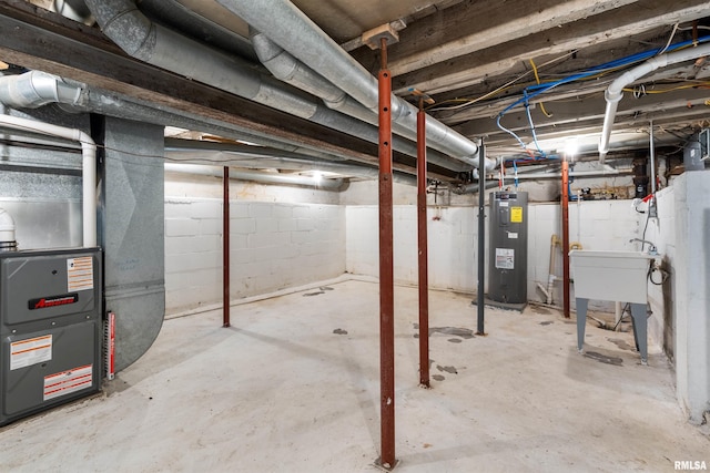 unfinished basement with water heater and heating unit