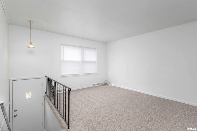 carpeted empty room featuring baseboards