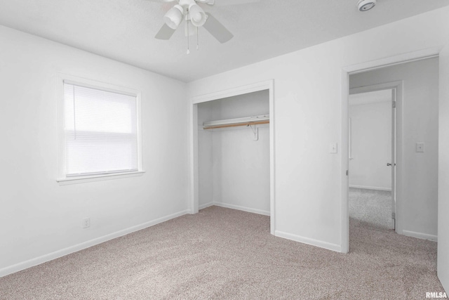 unfurnished bedroom with carpet floors, a closet, and baseboards