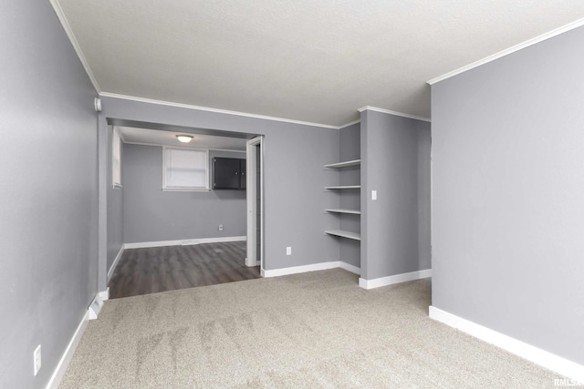 interior space with carpet floors, crown molding, a textured ceiling, and baseboards